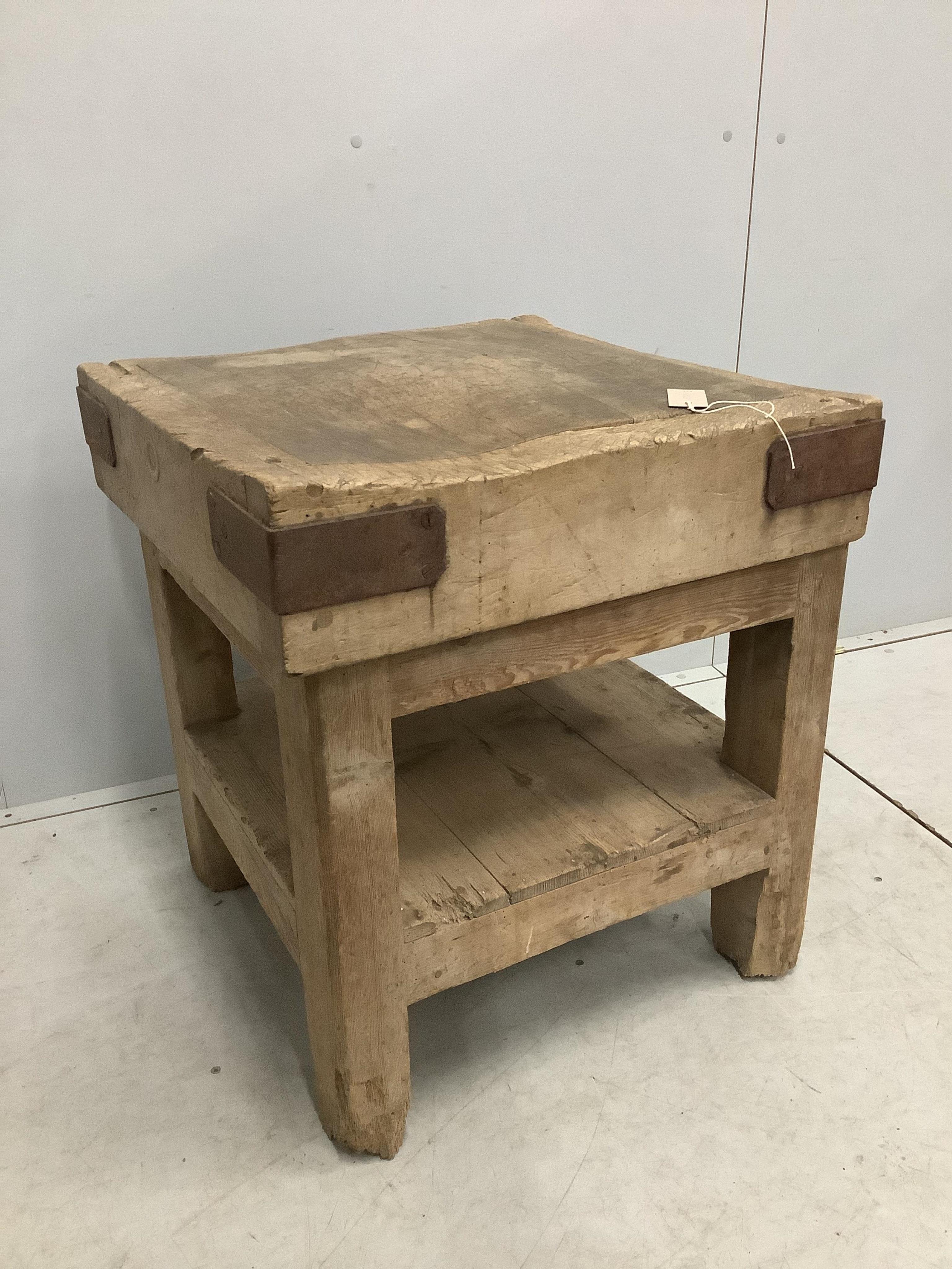 A Victorian iron bound butcher's block on pine stand, width 62cm, depth 61cm, height 68cm. Condition - fair